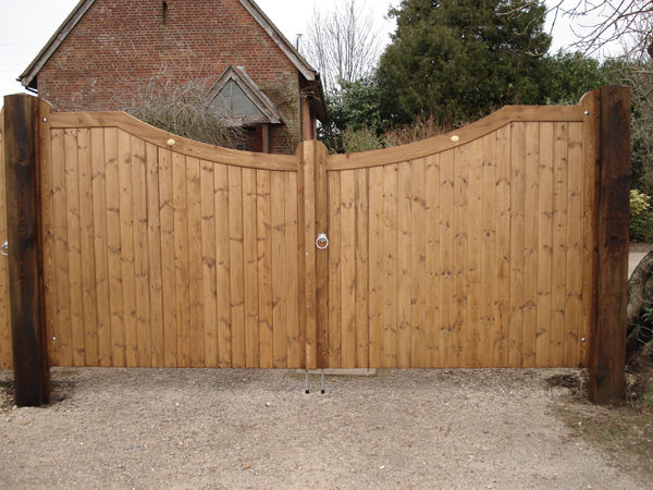 Pair of curved-top timber driveway gates on oak posts