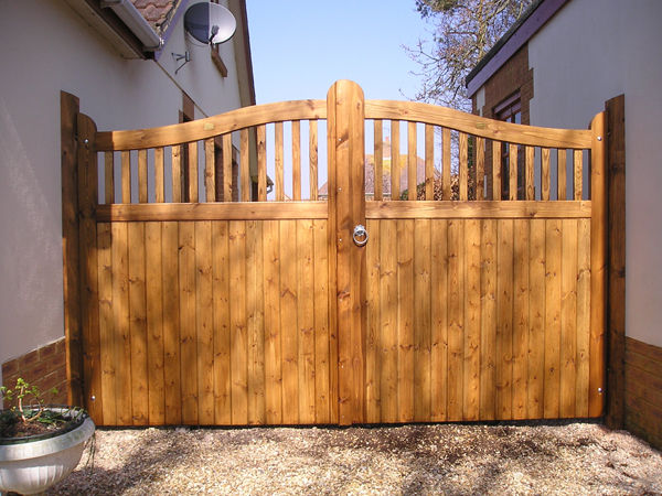 Timber driveway gates with an arched spindle top