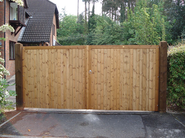 Pair of close-boarded softwood driveway gates hung on timber posts